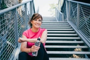 Healthy Menopausal Woman in exercise clothes and water bottle